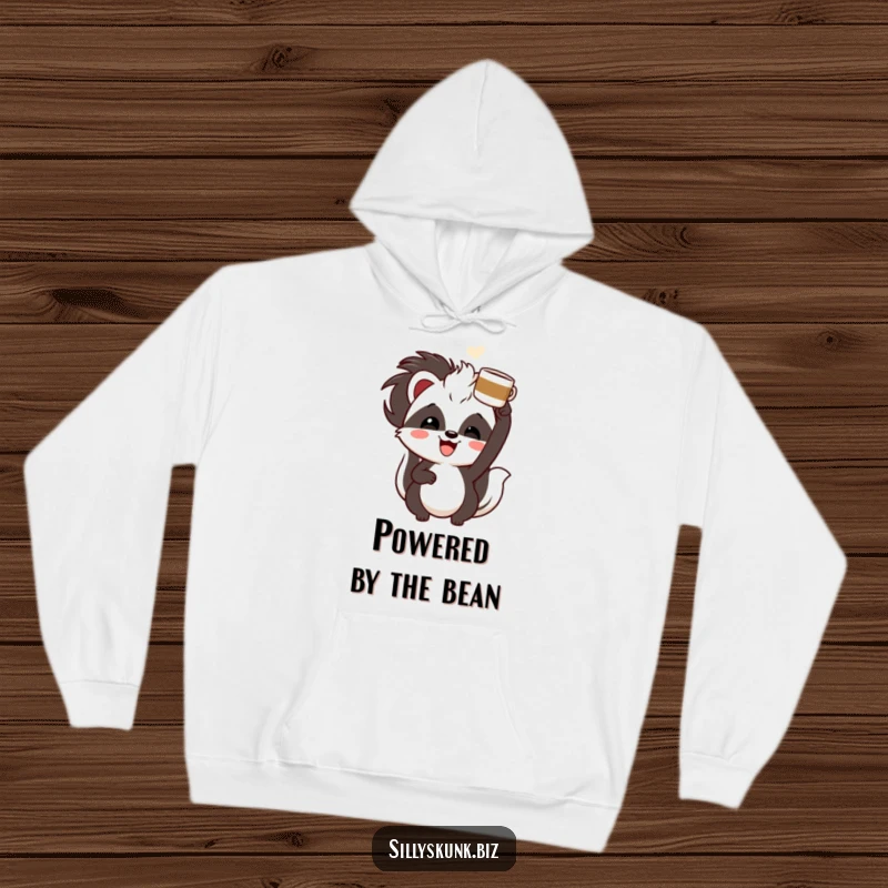 Funny skunk with a cheerful grin, enthusiastically holding a coffee cup overhead, a cozy and humorous hoodie.